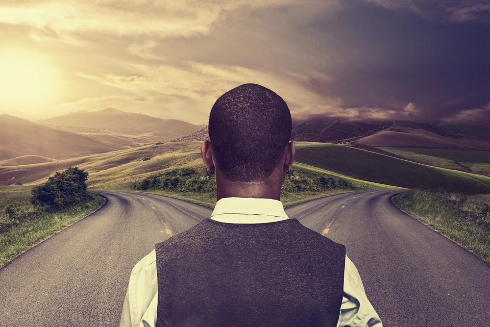 businessman in front of two roads hoping for best taking chance.jpeg